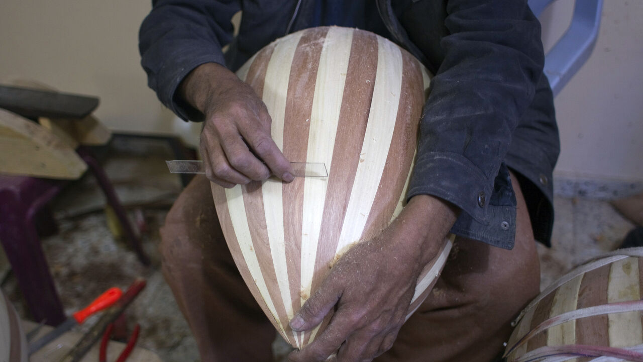 470353043 Hammad Atwa, a Palestinian man who makes lutes, known in Arabic as an "Oud", works on a musical instrument at the Khan Younis refugee camp in the southern Gaza Strip on February 19, 2014. Hammad sells his handmade lutes for 300 American dollars a piece. AFP PHOTO / SAID KHATIB (Photo credit should read SAID KHATIB/AFP via Getty Images)