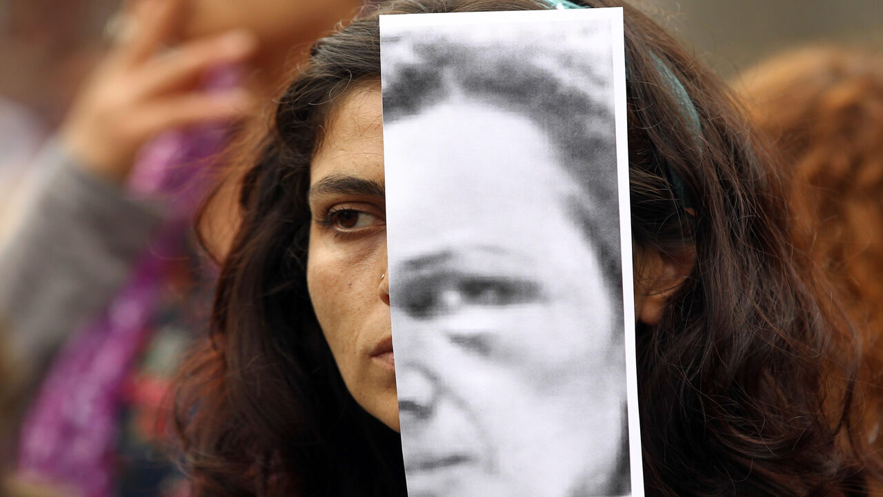 476862560 Turkish women display photographs of slain student, Özgecan Aslan, who was killed while resiting an attempted rape, and other victims of violence against women during a demonstration in Ankara on June 12, 2015. Three men went on trial in Turkey over the murder and attempted rape of a 20-year-old female student, in a case that sparked an outpouring of anger over the level of violence against women in the country. Ozgecan Aslan was murdered in the southern region of Mersin in February while returning home f