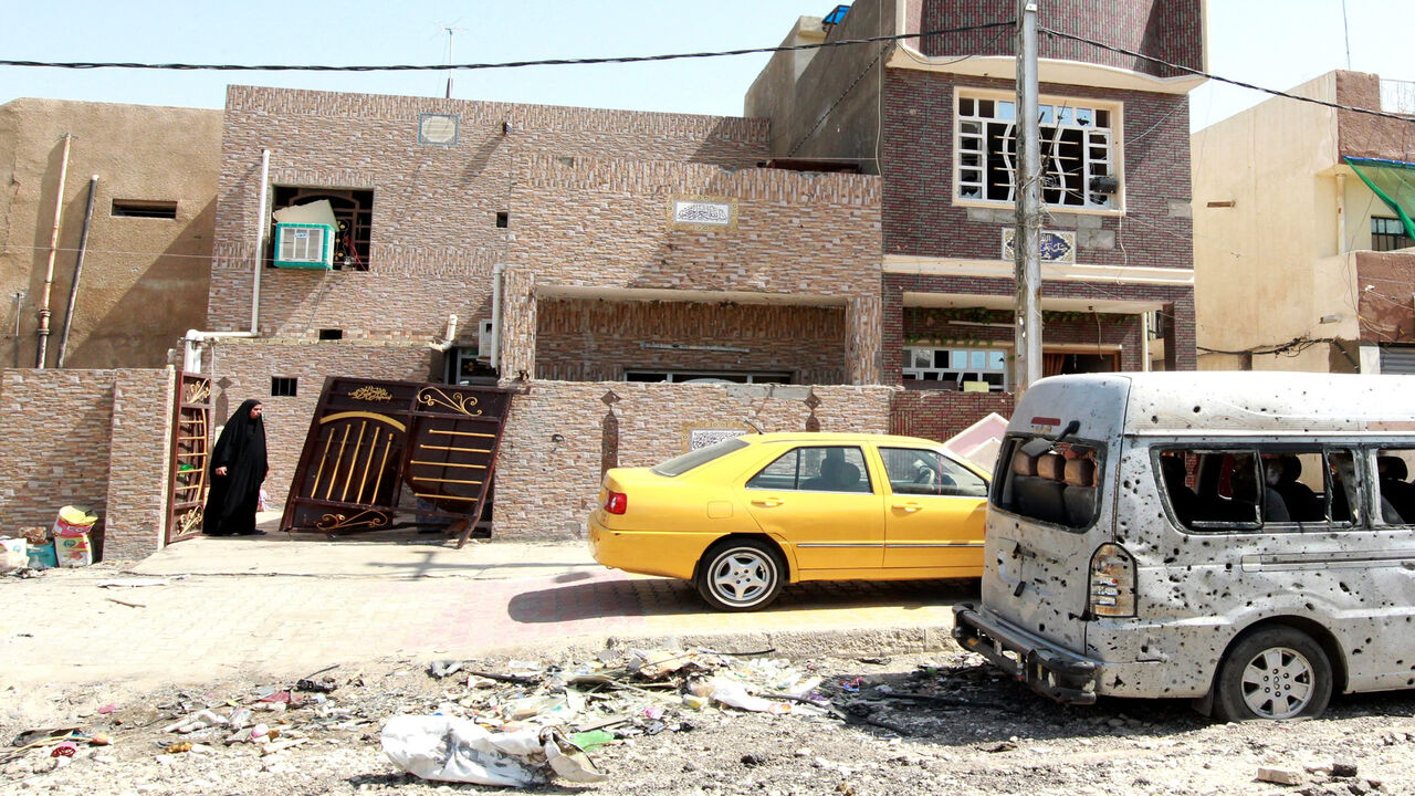480562630 An Iraqi woman looks at the damage outside her house in a residential area of the capital, Baghdad, on July 13, 2015, the day after a car bomb explosion. A string of bomb explosions, including two suicide attacks, killed at least 21 people and wounded 62 in Shiite-dominated neighbourhoods of Baghdad, Iraqi police and medical sources said. AFP PHOTO / SABAH ARAR (Photo credit should read SABAH ARAR/AFP via Getty Images)