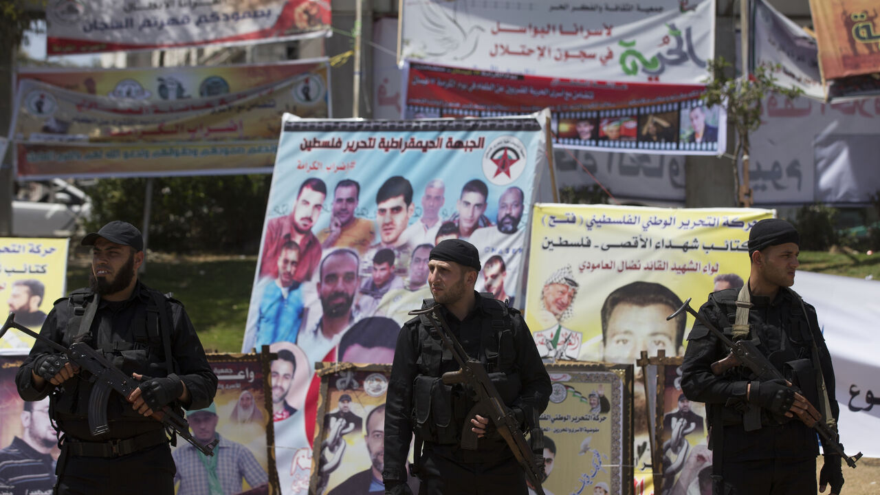 680319768 Hamas security forces stand guard during a visit of newly elected Hamas chief, Ismail Haniya, to protesters taking part in a sit-in in support of Palestinian hunger-striking prisoners held in Israeli jails, on May 8, 2017, in Gaza City. / AFP PHOTO / MAHMUD HAMS (Photo credit should read MAHMUD HAMS/AFP via Getty Images)