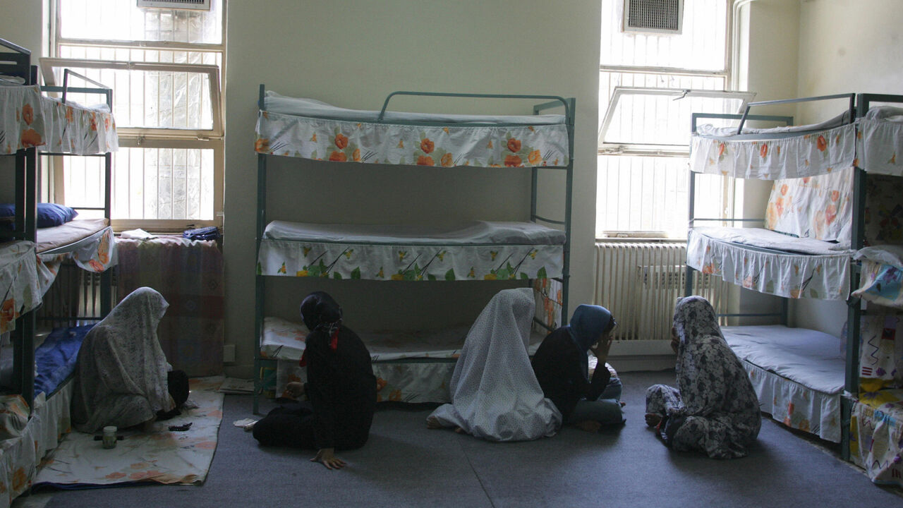 71193370 Tehran, IRAN: TO GO WITH AFP STORY IRAN-JUSTICE-PRISON-SOCIT BY PIERRE CELERIER Iranian women inmates sit at their cell in the infamous Evin jail, north of Tehran, 13 June 2006. AFP PHOTO/ATTA KENARE (Photo credit should read ATTA KENARE/AFP via Getty Images)