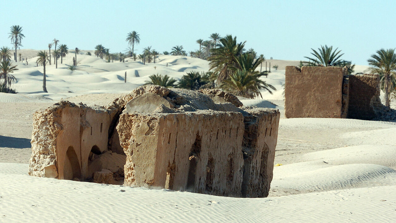 72873826 DOUZ, TUNISIA: An abandoned Berber village sits in dunes in the vicinity of Zaafarane, near the southern Tunisian town of Douz, 24 December 2006 as the 39th International Sahara Festival opens. The festival, held 600 kms (370 miles) south of Tunis, draws locals and tourists for a cultural event that celebrates the region's heritage and desert people. AFP PHOTO FETHI BELAID (Photo credit should read FETHI BELAID/AFP via Getty Images)