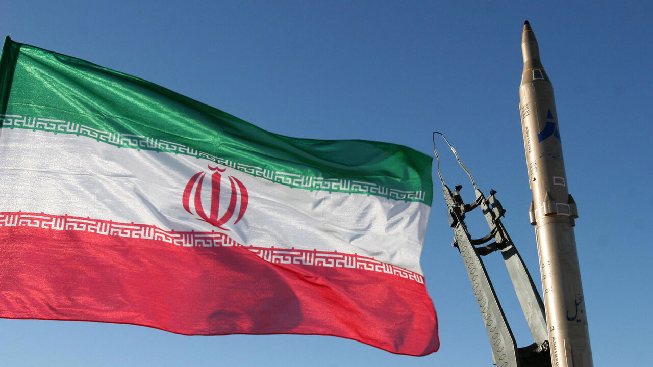 83659141 An Iranian flag flutters next to a ground-to-ground Sajil missile before being launched at an undisclosed location in Iran on November 12, 2008. Iran test fired today a new generation of ground-to-ground missile, the semi-official Fars news agency quoted the defence minister as saying. In the past Iran has often boasted of developing new weapons systems only to be met with scepticism from Western defence analysts. AFP PHOTO/FARS NEWS/STR (Photo credit should read -/AFP via Getty Images)