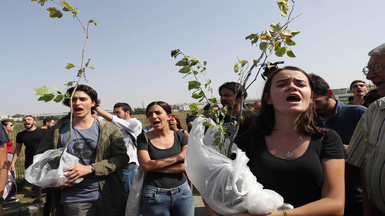845273732 University students carrying young trees and members of the Middle East Technical Universuty (METU) graduate association protest against a road construction project to be carried out from the METU forests, on September 10, 2017 in Ankara. / AFP PHOTO / ADEM ALTAN (Photo credit should read ADEM ALTAN/AFP via Getty Images)