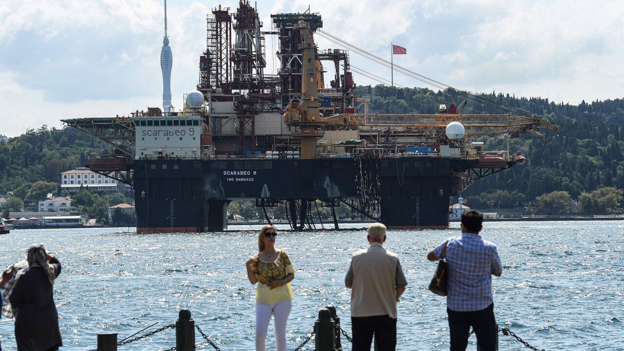 1164607037 People watch as Scarabeo 9, a 115-meter-long and 78-meter-high Frigstad D90-type semi-submersible drilling rig, passes on the Bosphorus Strait en route to the Black Sea in Istanbul on August 29, 2019. - The semi-submersible drilling rig is owned and operated by Italian oil and gas industry contractor Saipem and registered in Nassau, Bahamas. (Photo by Ozan KOSE / AFP) (Photo credit should read OZAN KOSE/AFP via Getty Images)
