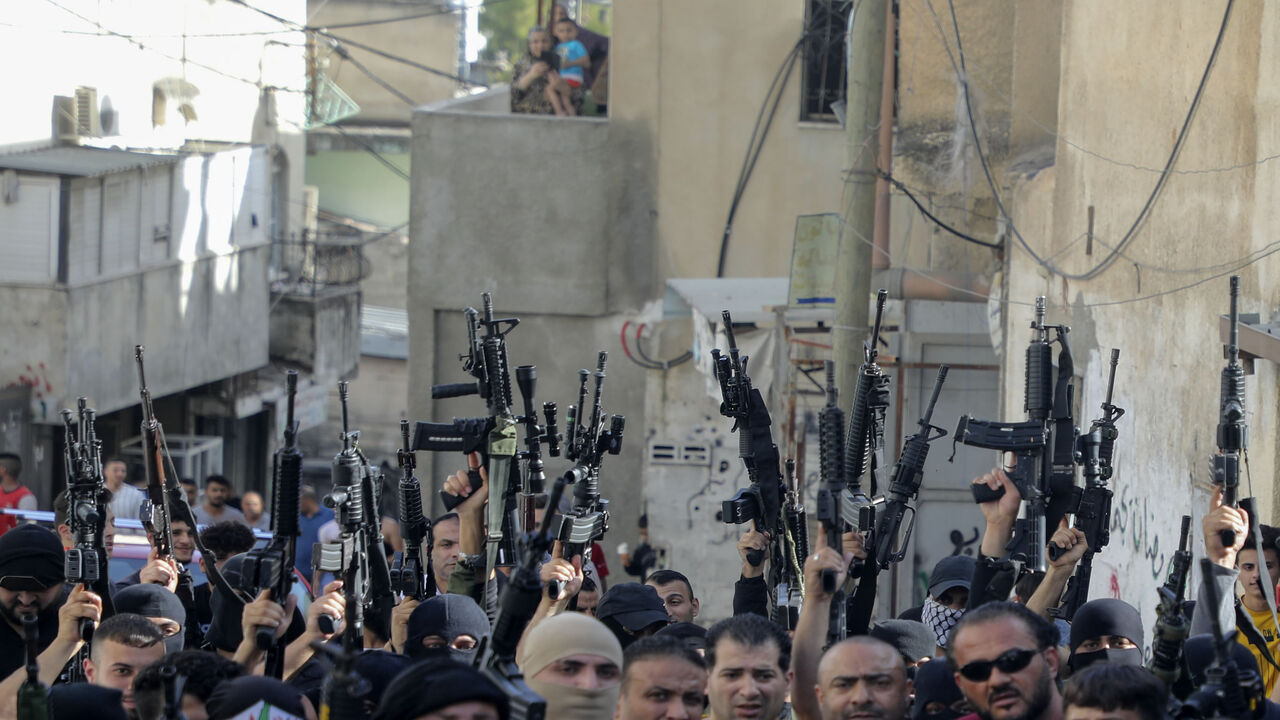 1218190395 TOPSHOT - Armed members of the Palestinian Fatah movement take part in a march in the Al-Ain camp, west of Nablus in the West Bank, on June 7, 2020, to protest Israel's plan to annex parts of the occupied Palestinian territory and express support for President Mahmoud Abbas. (Photo by JAAFAR ASHTIYEH / AFP) (Photo by JAAFAR ASHTIYEH/AFP via Getty Images)