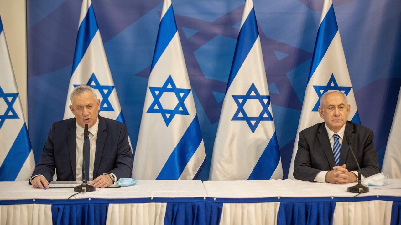 1227805213 Israeli Prime Minister Benjamin Netanyahu (R) and alternate Prime Minister and Defence Minister Benny Gantz (L) issue a statement at the Israeli Defence Ministry in Tel Aviv on July 27, 2020 following the high tensions with the Lebanese militant group Hezbollah at the Israeli-Lebanon border. (Photo by Tal SHAHAR / POOL / AFP) (Photo by TAL SHAHAR/POOL/AFP via Getty Images)