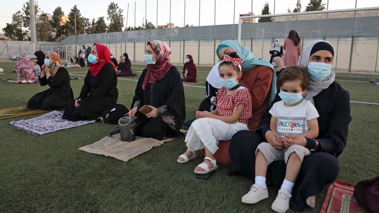 1227849996 Palestinian Muslim worshippers pray on July 31, 2020 at the municipal stadium in the village of Dura on the first day of Eid al-Adha. - Eid al-Adha (the Festival of Sacrifice) is celebrated throughout the Muslim world as a commemoration of Abraham's willingness to sacrifice his son for God, and cows, camels, goats and sheep are traditionally slaughtered on the holiest day (Photo by HAZEM BADER / AFP) (Photo by HAZEM BADER/AFP via Getty Images)