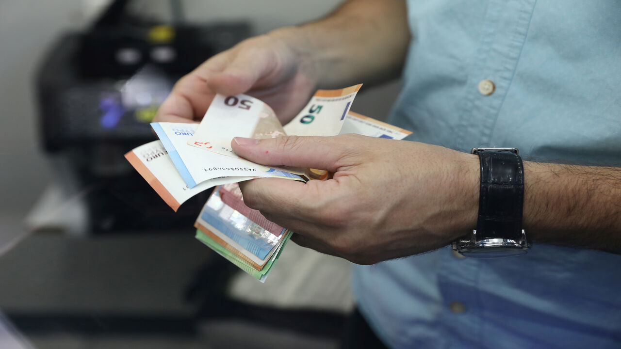 1227951320 An employee counts money at a currency exchange office in Ankara, on August 7, 2020. - Turkey's lira on August 7, 2020 set a new record low against the US dollar as investors worried about the government's economic policies and dollar reserves appeared to be running low. (Photo by Adem ALTAN / AFP) (Photo by ADEM ALTAN/AFP via Getty Images)