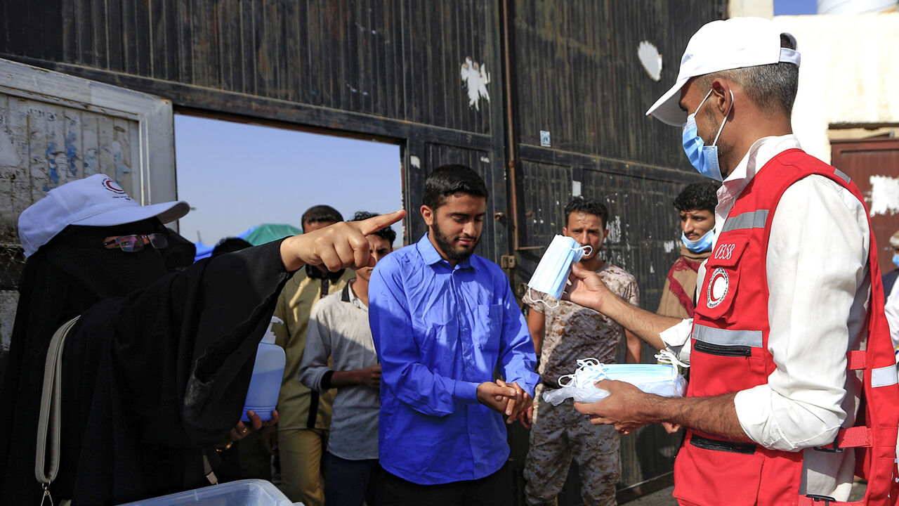 1228056179 Face masks are distributed to Yemeni students upon their arrival to sit for their final secondary school exams in the capital Sanaa on August 15, 2020, amid the coronavirus pandemic crisis. (Photo by Mohammed HUWAIS / AFP) (Photo by MOHAMMED HUWAIS/AFP via Getty Images)