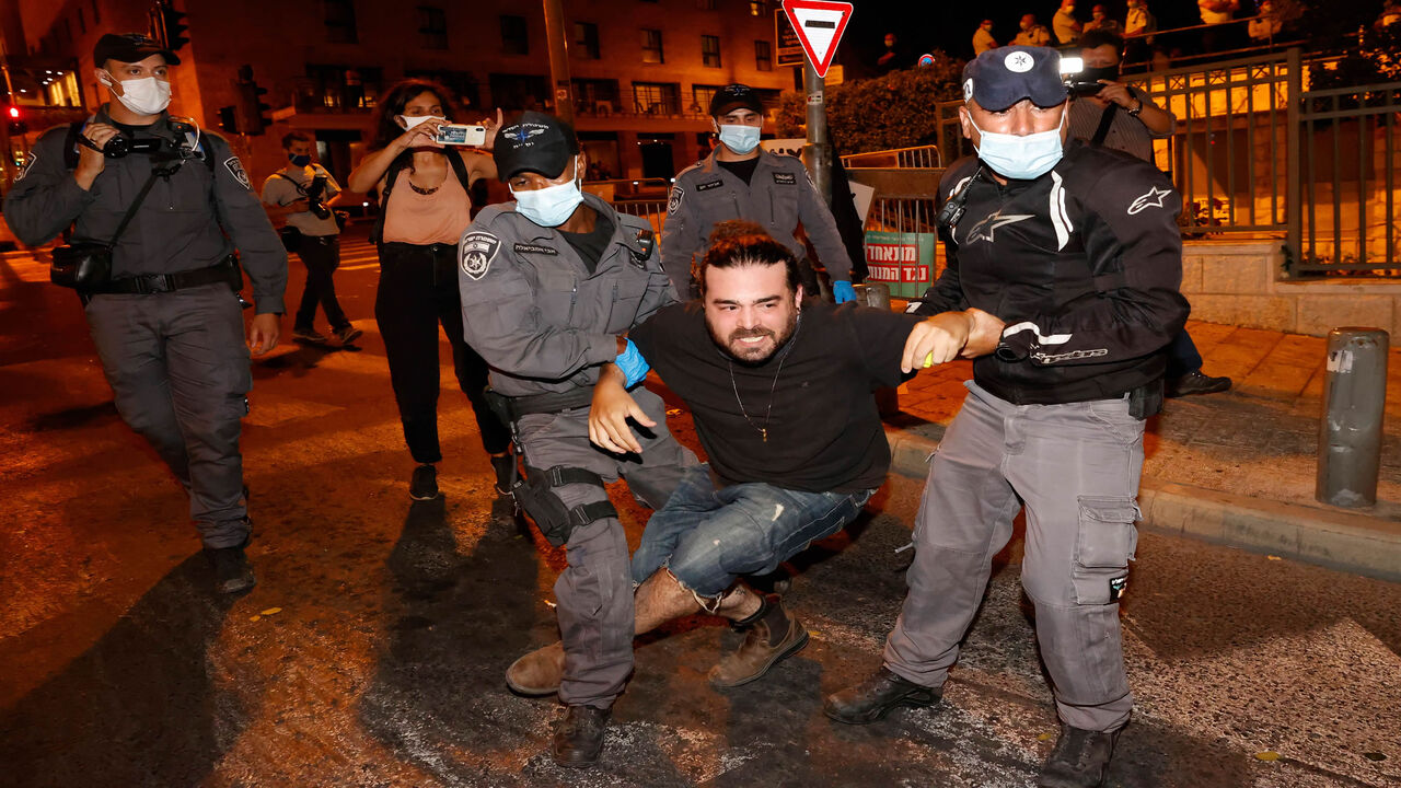 1228061602 Police remove protesters blocking a main road during a demonstration against the Israeli government near the Prime Minister's residence in Jerusalem on August 16, 2020. (Photo by JACK GUEZ / AFP) (Photo by JACK GUEZ/AFP via Getty Images)