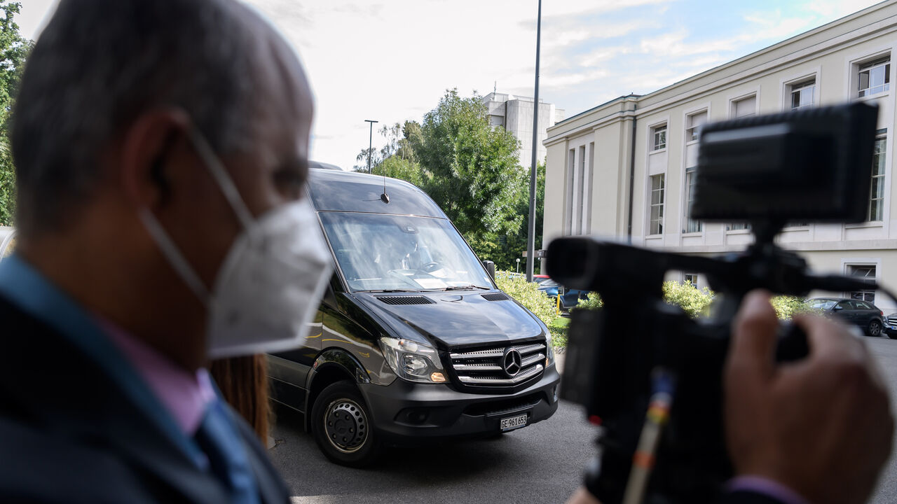 1228179644 A journalist wearing a protective face mask films the arrival of the bus carrying a delegation taking part in a meeting of Syria Constitutional Committee at the United Nations (UN) Office in Geneva on August 24, 2020. - Members of Syria's Constitutional Committee will be meeting for the first time since last November, following delays brought on by the coronavirus crisis. (Photo by Fabrice COFFRINI / AFP) (Photo by FABRICE COFFRINI/AFP via Getty Images)