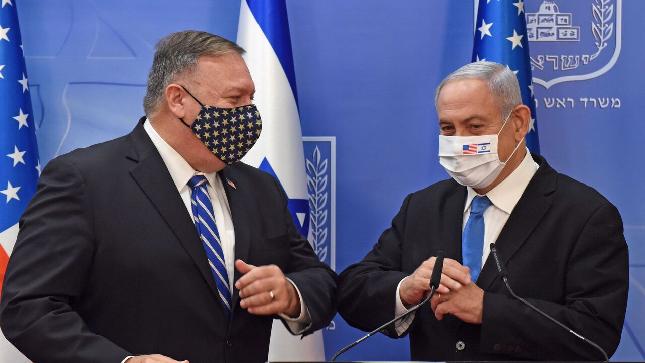 1228180913 US Secretary of State Mike Pompeo (L) and Israeli Prime Minister Benjamin Netanyahu bump elbows ahead of making a joint statement to the press after meeting in Jerusalem, on August 24, 2020. - Pompeo arrived in Israel kicking off a five-day visit to the Middle East which will take him to Sudan, the United Arab Emirates, and Bahrain, focusing on Israel's normalising of ties with the UAE and pushing other Arab states to follow suit. (Photo by DEBBIE HILL / POOL / AFP) (Photo by DEBBIE HILL/POOL/AFP via Getty