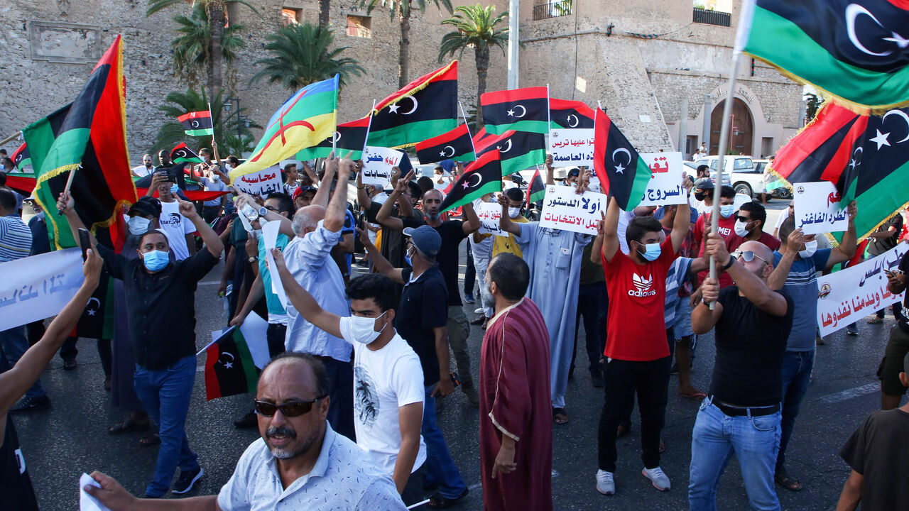 1228199943 Libyans chant slogans during a demonstration due to poor public services at the Martyrs' Square at the centre of the GNA-held Libyan capital Tripoli on August 25, 2020. - Angered by chronic water, power, and petrol shortages in a country with Africa's largest proven crude oil reserves, the mostly young people had marched through the city centre chanting slogans including "No to corruption!" (Photo by - / AFP) (Photo by -/AFP via Getty Images)