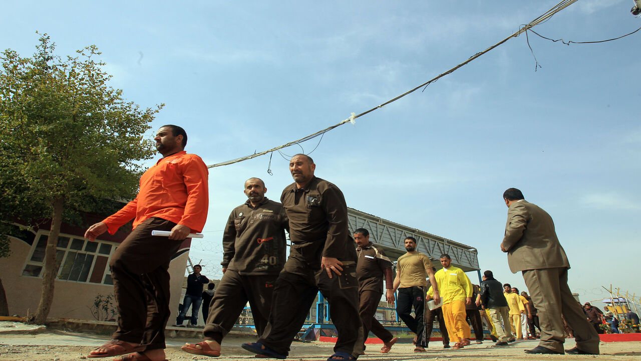 162827522 Iraqi detainees leave the prison after being freed on February 28, 2013 in the Iraqi capital Baghdad. 160 prisoners were freed today and Iraq has freed 4,000 prisoners since the beginning of 2013, Deputy Prime Minister Hussein al-Shahristani said Thursday, in an apparent bid to placate protesters in Sunni areas of the country. AFP/ PHOTO/ ALI AL-SAADI (Photo credit should read ALI AL-SAADI/AFP via Getty Images)
