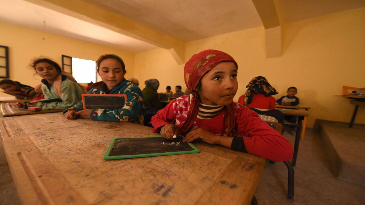 516911822 Children sit in a classroom at a school in the Moroccan village of Taghzirt, in el-Haouz province in the High Atlas Mountains south of the capital of Marrakech, on March 4, 2016.
When using well-known search engines, one can find very few information about Taghzirt village. And while tourists from all around the world enjoy the sun warm days and the snow-covered view of the nearby mountains from Marrakesh, hundreds of villagers suffer from the harshness of winter and isolation, due to the state of the roads