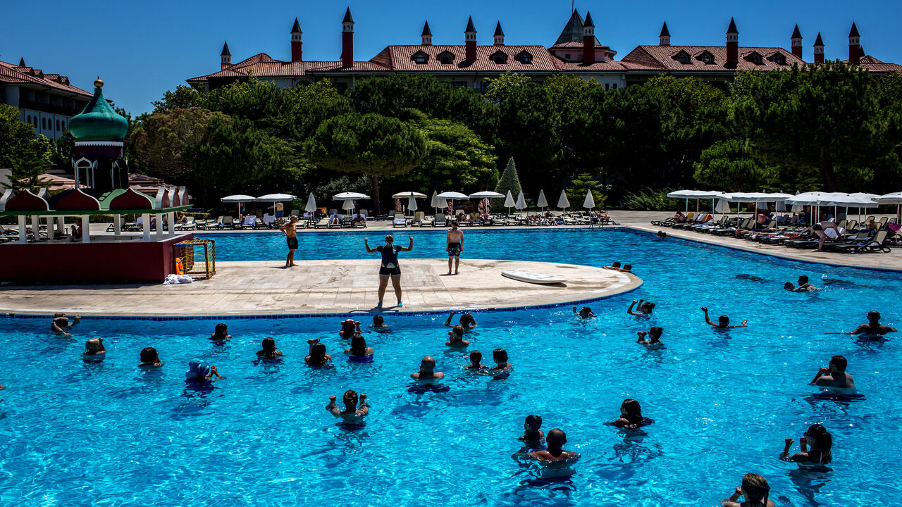 547188138 ANTALYA, TURKEY - JULY 12: Tourists take part in an aqua aerobics session at an all inclusive Russian themed resort on July 12, 2016 in Antalya, Turkey. Russian President Vladimir Putin last month officially lifted travel restrictions on tourism to Turkey. Russia had banned agency tours to Turkey after a diplomatic crisis erupted when Turkey downed a Russian jet on the Turkey - Syrian border in November 2015. Turkey's tourism is currently in crisis after a series of terrorist attacks, most recently the bom