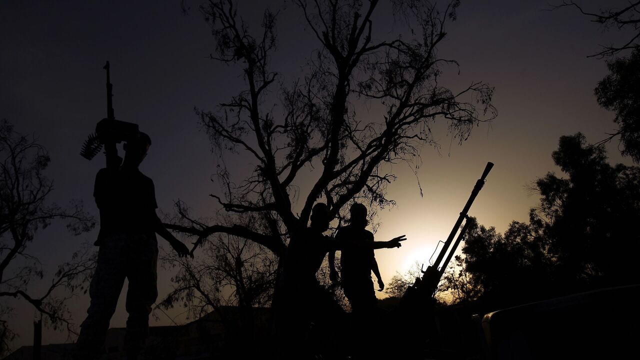 692810376 TOPSHOT - Members of the Salah Bou-Haliqa brigade, loyal to the country's east strongman Khalifa Haftar's self-styled Libyan National Army, celebrate as they arrive in the eastern city of Benghazi after seizing the central al-Jufra area from the Benghazi Defence Brigades coalition, a rival to Haftar's forces on June 5, 2017. / AFP PHOTO / Abdullah DOMA (Photo credit should read ABDULLAH DOMA/AFP via Getty Images)