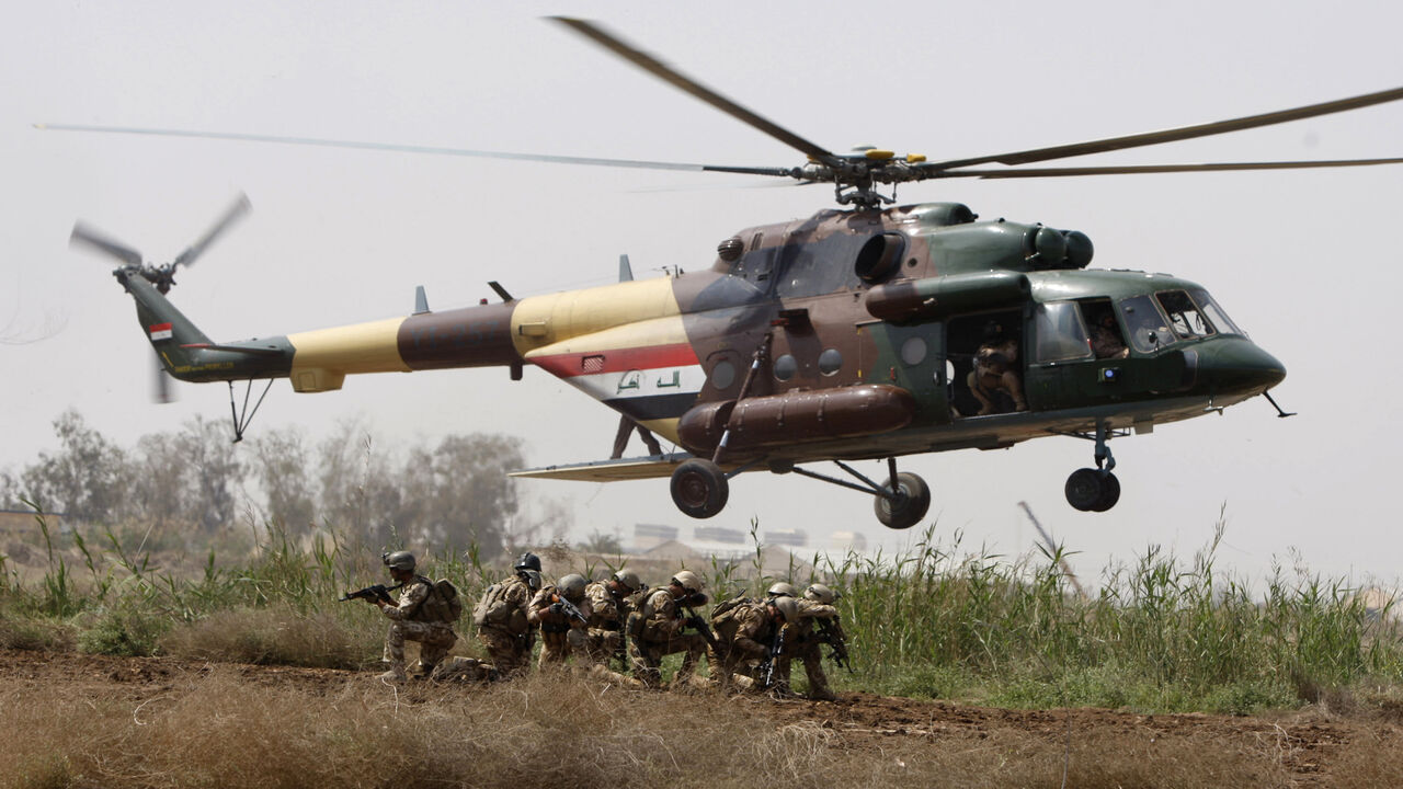 98113192 Iraqi soldiers take position as they disembark from an MI171 helicopter during a joint land and air training with US soldiers from 1st Air Cavalry Brigade at Camp Taji, 25kms north of Baghdad, on March 29, 2010. AFP PHOTO/AHMAD AL-RUBAYE (Photo credit should read AHMAD AL-RUBAYE/AFP via Getty Images)