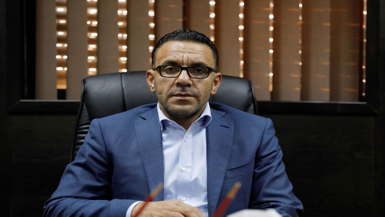 1057266712 Governor of Jerusalem for the Palestinian Authority Adnan Ghaith poses for a photograph in his office at the Palestinian Ministry of Jerusalem affairs' headquarters in the occupied West Bank town of al-Ram, near Jerusalem, on November 4, 2018. - Israeli forces raided the offices of the Palestinian governor of Jerusalem on November 4, authorities said, after reports of an investigation related to a land sale. Israeli authorities confirmed the raid in Al-Ram, just on the other side of Israel's separation wall
