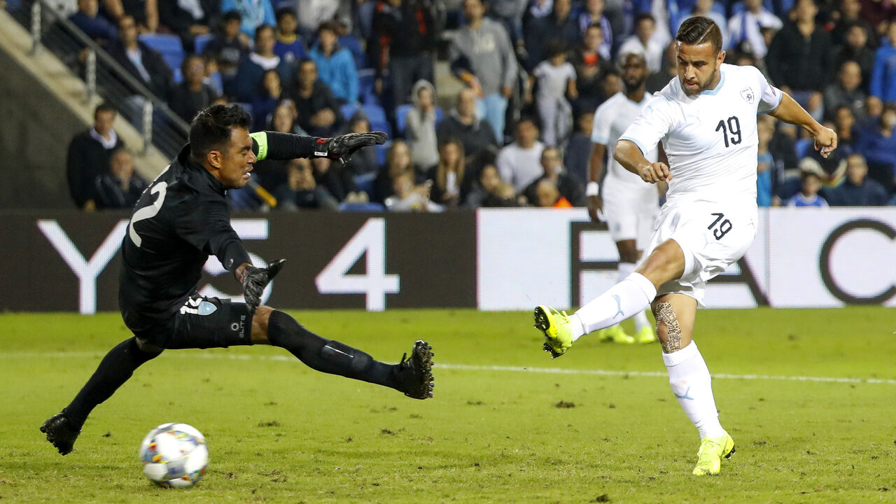 1061939418 Israel's midfielder Dia Saba (R) shoots the ball past Guatemala's goalkeeper Paulo Motta as he scores during the FIFA friendly football match between Israel and Guatemala at Netanya Municipal Stadium in the Israeli coastal city of Netanya on November 15, 2018. (Photo by JACK GUEZ / AFP) (Photo credit should read JACK GUEZ/AFP via Getty Images)