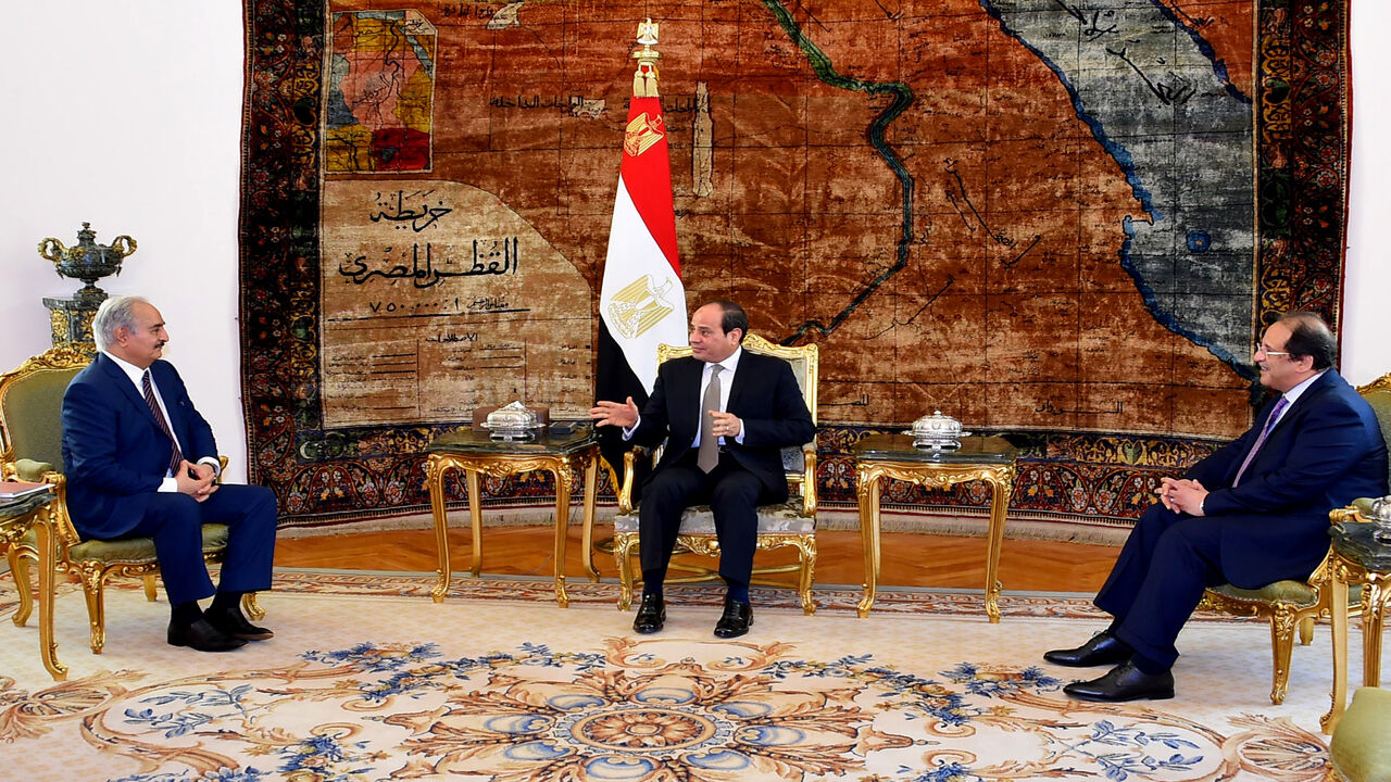 1137086386 This handout picture released by the Egyptian Presidency on April 14, 2019, shows Egyptian president Abdel Fattah al-Sisi (C) and intelligence chief Abbas Kamel (R) meeting Libyan strongman Khalifa Haftar (L) at the Ittihadia presidential Palace in the capital Cairo. - Egyptian President Abdel Fattah al-Sisi met Sunday with Libyan commander Khalifa Haftar whose forces are fighting for control of the capital Tripoli, state media reported. Sisi has been an ardent supporter of Haftar's forces, which control sw