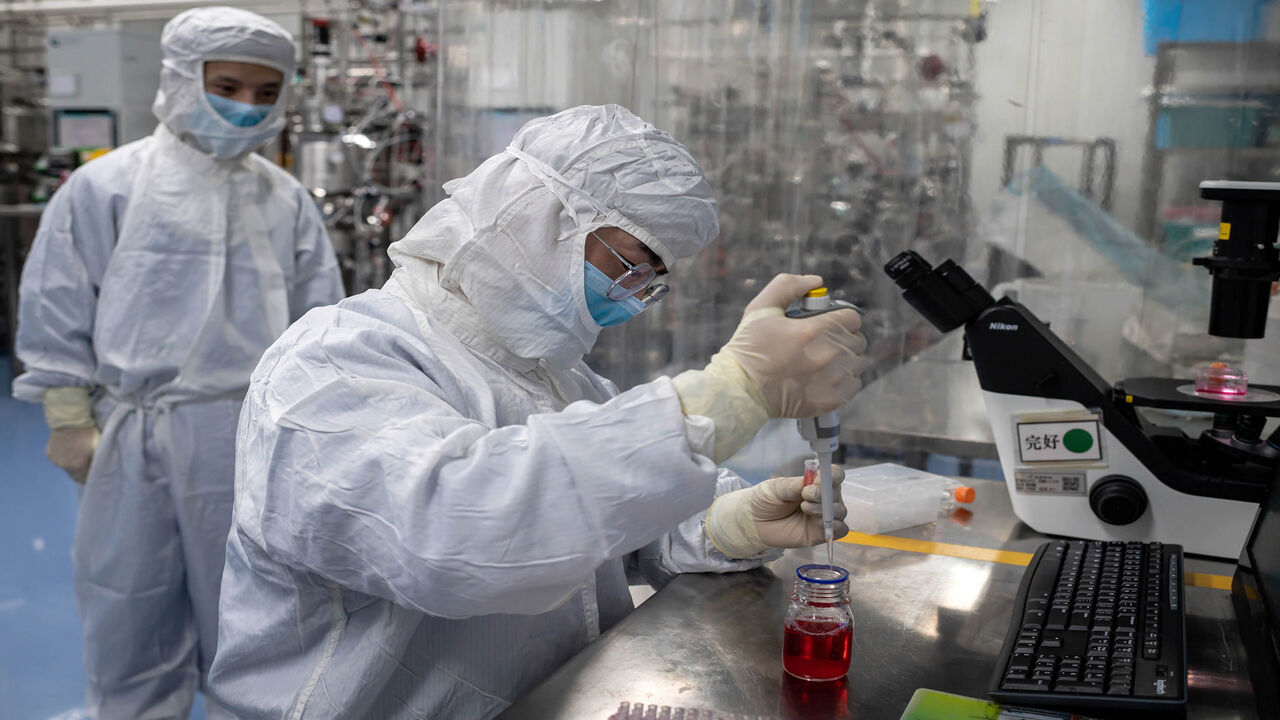 1211365750 In this picture taken on April 29, 2020, an engineer takes samples of monkey kidney cells as he make tests on an experimental vaccine for the COVID-19 coronavirus inside the Cells Culture Room laboratory at the Sinovac Biotech facilities in Beijing. - Sinovac Biotech, which is conducting one of the four clinical trials that have been authorised in China, has claimed great progress in its research and promising results among monkeys. (Photo by NICOLAS ASFOURI / AFP) / TO GO WITH Health-virus-China-vaccine,FO