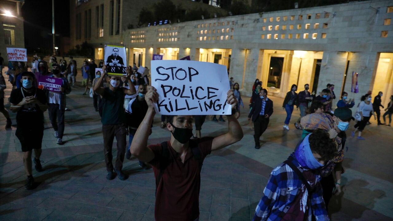 1218984711 Israeli left-wing activists attend a protest against the killing of Iyad Hallak, a disabled Palestinian man shot dead by Israeli police, in Jerusalem on June 9, 2020. (Photo by Ahmad GHARABLI / AFP) (Photo by AHMAD GHARABLI/AFP via Getty Images)
