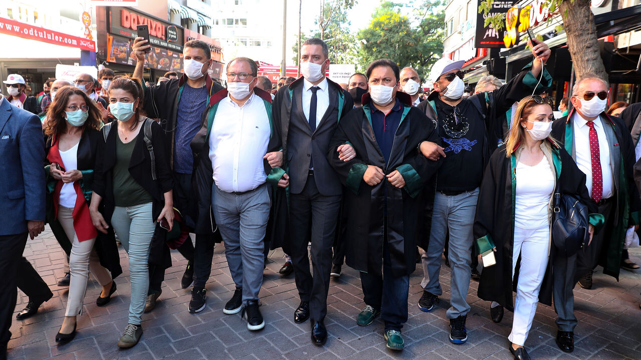 1226032877 Protesting lawyers lock arms as they march during a demonstration against a government draft bill on changing the system of bar associations on July 10, 2020, in Ankara. - Turkey's ruling party on June 30 presented a bill to parliament on changing the system of bar associations that opponents say will dent lawyers' independence and influence. (Photo by Adem ALTAN / AFP) (Photo by ADEM ALTAN/AFP via Getty Images)