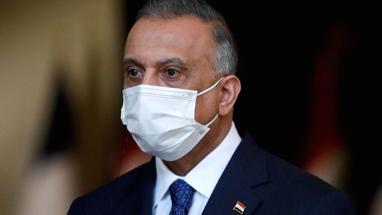 1228310814 Iraq's Prime Minister Mustafa al-Kadhemi, mask-clad due to the COVID-19 coronavirus pandemic, looks on during a joint press conference with the French president in Baghdad on September 2, 2020. - French President Emmanuel Macron landed in Baghdad on his first official trip to Iraq, where he hopes to help the country reassert its "sovereignty" after years of conflict. (Photo by GONZALO FUENTES / POOL / AFP) (Photo by GONZALO FUENTES/POOL/AFP via Getty Images)