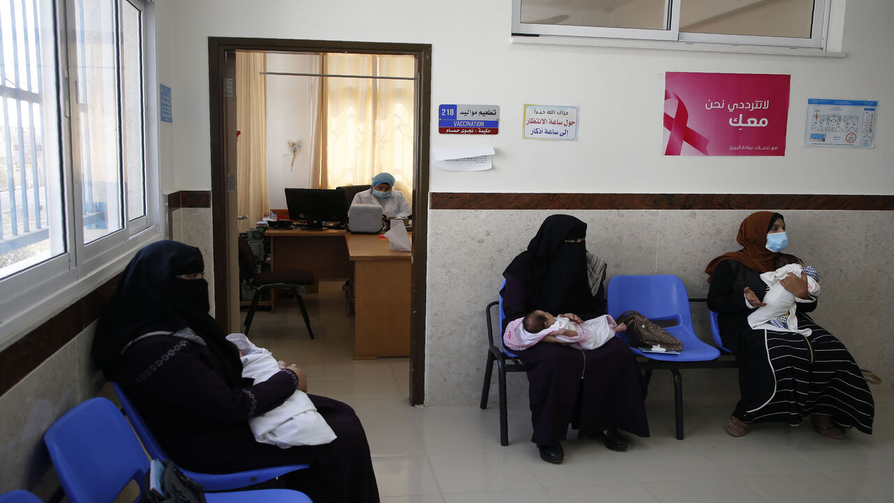 1228419957 Palestinian women mask-clad due to the Covid-19 coronavirus pandemic wait with their children in a UN clinic to take Polio vaccine and Rota virus vaccines at Bureij refugee camp in the central of Gaza Strip on September 9, 2020. (Photo by MOHAMMED ABED / AFP) (Photo by MOHAMMED ABED/AFP via Getty Images)