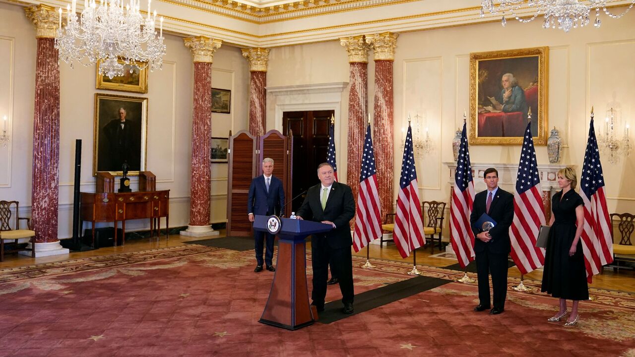 1228638696 US Secretary of State Mike Pompeo speaks during a news conference to announce the Trump administration's restoration of sanctions on Iran, on September 21, 2020, at the US State Department in Washington,DC. - Standing behind Pompeo are (L-R), National security adviser Robert O'Brien, Defense Secretary Mark Esper and US Ambassador to the United Nations Kelly Craft. The United States said Monday it was imposing sanctions on Iran's defense ministry and Venezuelan President Nicolas Maduro under a UN authority w