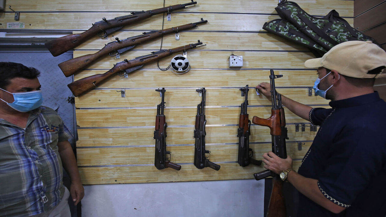 1228649885 Employees display rifles for sale at a gun shop in the Iraqi capital Baghdad on September 22, 2020. (Photo by AHMAD AL-RUBAYE / AFP) (Photo by AHMAD AL-RUBAYE/AFP via Getty Images)
