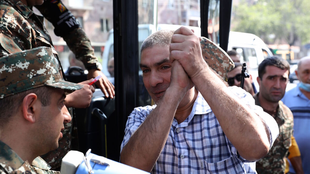 A man gestures boarding a bus to depart to the breakaway Nagorno-Karabakh region after Armenian authorities declared military mobilisation following armed clashes with Azerbaijan, Yerevan, September 28, 2020. (Photo by Stepan Poghosyan / PHOTOLURE / AFP) (Photo by STEPAN POGHOSYAN/PHOTOLURE/AFP via Getty Images)