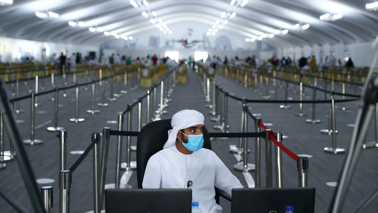 1264998220 ABU DHABI, UNITED ARAB EMIRATES - AUGUST 10: A workers is seen at a testing center at the Dubai-Abu Dhabi border on August 10, 2020 in Abu Dhabi, United Arab Emirates. The UAE has recorded around 62,000 cases of covid-19, with 357 deaths, among its population of 9.6 million people. New cases have steadily declined since a spike at the beginning of July. (Photo by Francois Nel/Getty Images)