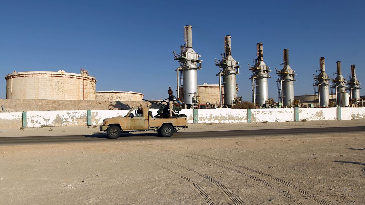 605719272 Forces opposed to Libya's unity government ride a truck in the Zueitina oil terminal on September 14, 2016.
Forces opposed to Libya's unity government handed management of four vital oil ports to the National Oil Company on September 14, after seizing them in a blow to fragile peace efforts. Prime minister-designate Fayez al-Sarraj called for urgent talks after the ports were captured by forces loyal to Field Marshal Khalifa Haftar, who supports a rival administration in the country's east.
/ AFP / Abdulla