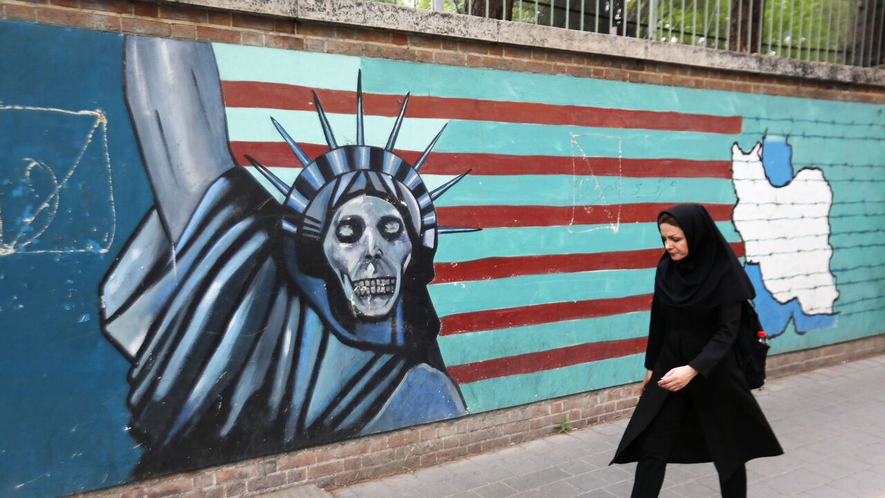 955945760 An Iranian woman walks past a mural on the wall of the former US embassy in the Iranian capital Tehran on May 8, 2018. - US President Donald Trump is due to make his decision on whether to rip up the 2015 nuclear deal and reimpose sanctions on Iran. (Photo by ATTA KENARE / AFP) (Photo credit should read ATTA KENARE/AFP via Getty Images)