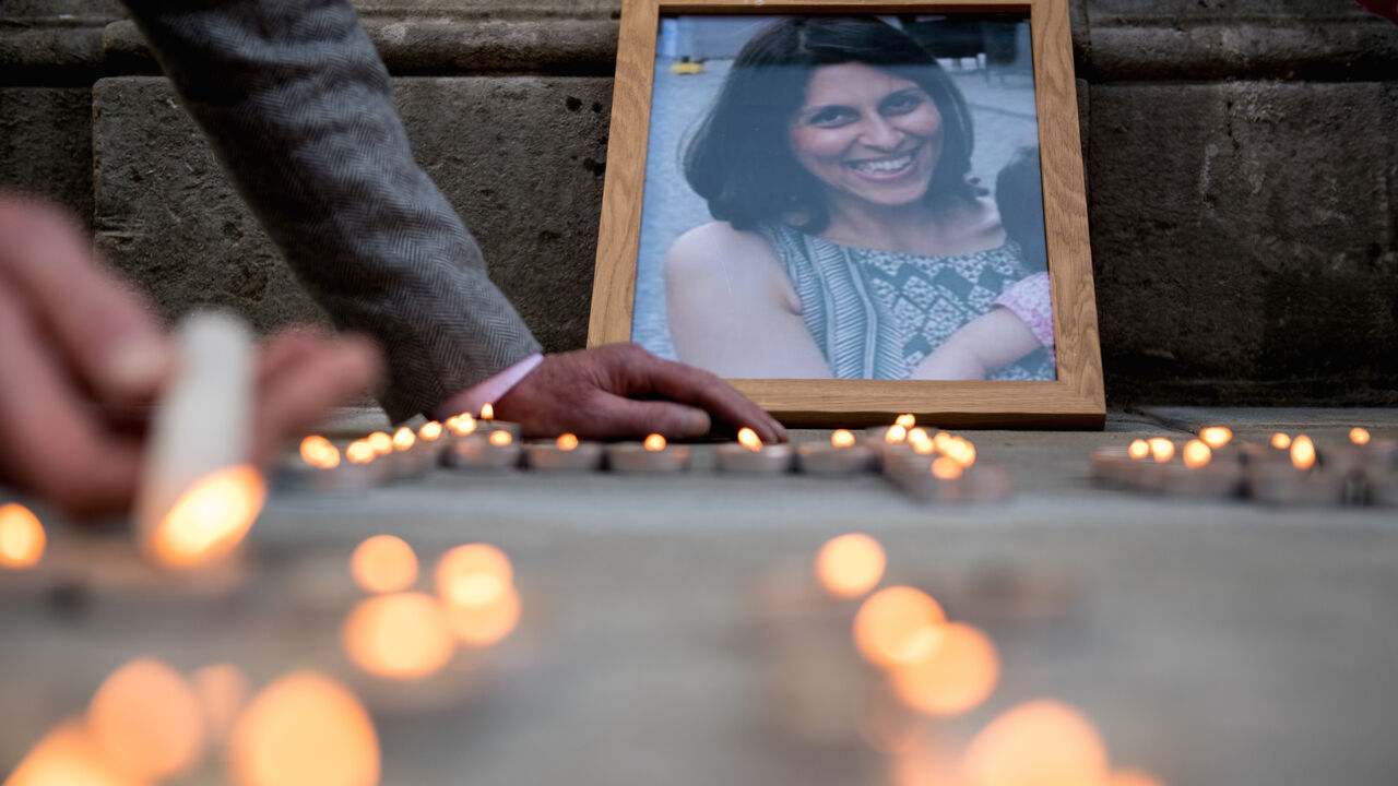 971650856 LONDON, ENGLAND - JUNE 11: A photo of Nazanin Zaghari-Ratcliffe is seen amongst candles during a fourth birthday vigil for her daughter Gabriella opposite the Foreign & Commonwealth Office, King Charles Street, London, SW1A on June 11, 2018 in London, England. Richard Ratcliffe has not seen his wife Nazanin Zaghari-Ratcliffe, 38, or daughter Gabriella, 4, since March 2016 when they flew to Iran to visit Nazanin's parents. At the airport on their return to London, Nazanin was arrested while Gabriella's pass