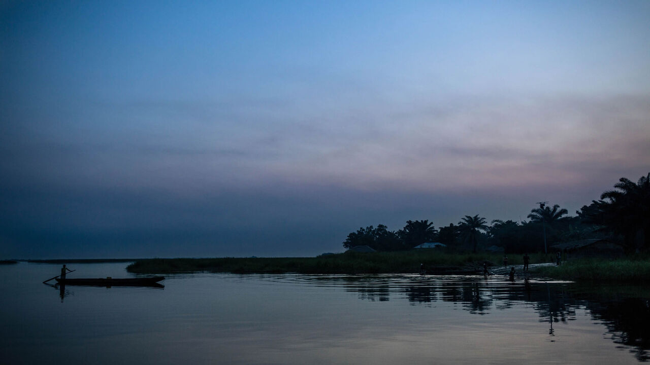 1095310826 A man drives a canoe on the Congo River near Makotimpoko, Republic of Congo, on January 25, 2019. - In Makotimpoko, nearly 16,000 people found refuge as they fled the ethnically motivated mass killings across the river in the Democratic Republic of Congo. Between December 16 and 17, 2018, at least 535 people were killed in Yumbi Territory, according to the United Nations Joint Office for Human Rights. (Photo by ALEXIS HUGUET / AFP) (Photo credit should read ALEXIS HUGUET/AFP via Getty Images)