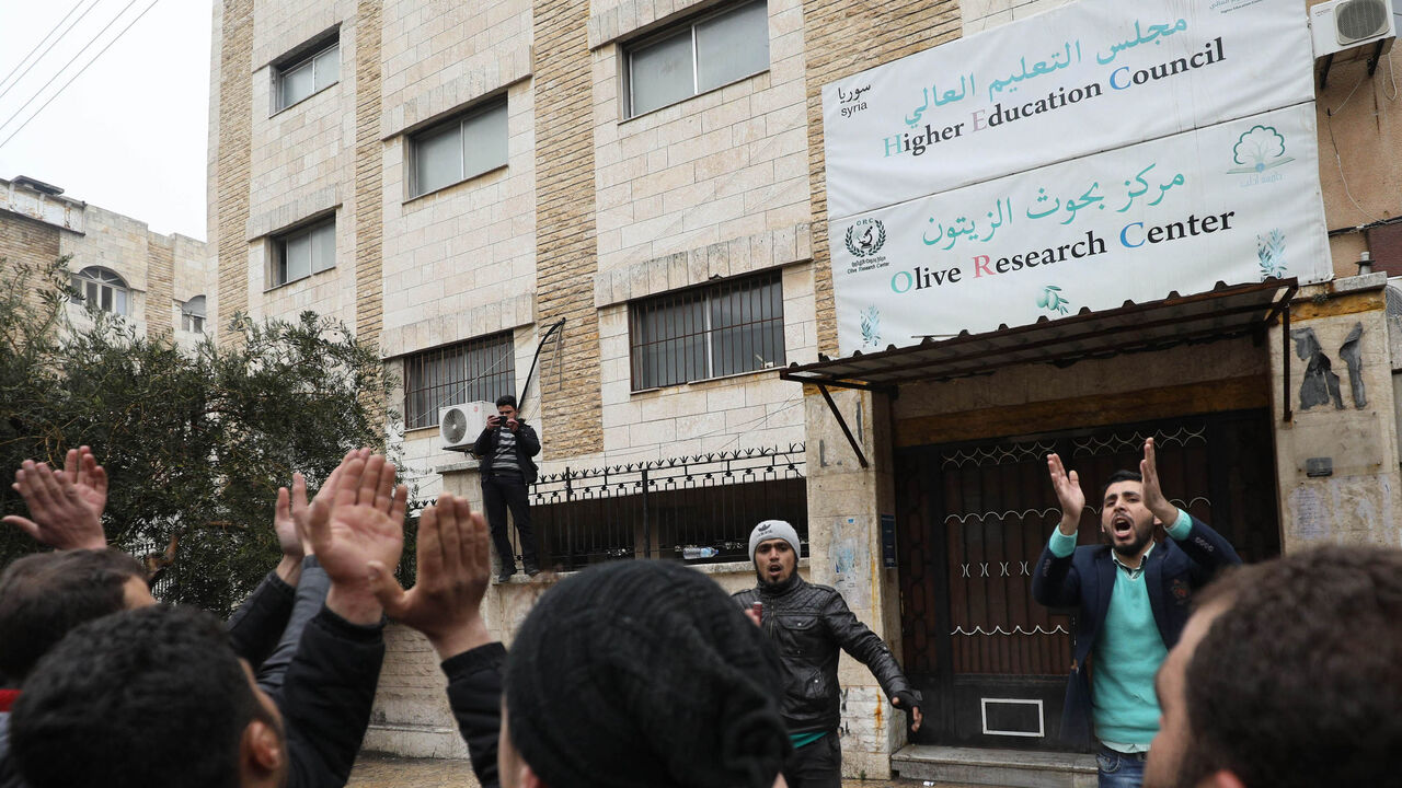 1128814713 Syrian university students protest in the city of Idlib on February 9, 2019 after jihadists of the Hayat Tahrir al-Sham organisation closed many private education centres in the north-western Syrian province of Idlib. - The Idlib region is mainly controlled by the jihadists of Hayat Tahrir al-Sham, a Syrian group led by former Al-Qaeda fighters, after they pushed back smaller, Turkey-backed rebel outfits last month. (Photo by OMAR HAJ KADOUR / AFP) (Photo credit should read OMAR HAJ KADOUR/AFP via Ge