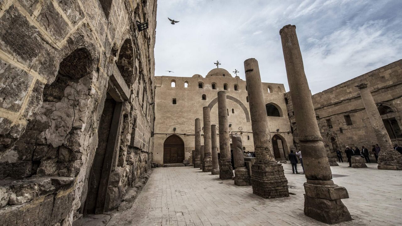 1135630809 This picture taken on April 6, 2019 shows a view of a courtyard in the Coptic Orthodox "White Monastery" of St Shenouda (Schenute) the Archimandrite in Egypt's southern Sohag province, about 500 kilometres south of the capital Cairo. - Dating back to the second half of the 5th century AD, the monastery is named name for the colour of its white limestone outside walls. It is architecturally similar to the nearby "Red Monastery". (Photo by Khaled DESOUKI / AFP) (Photo credit should read KHALED DESOUKI/