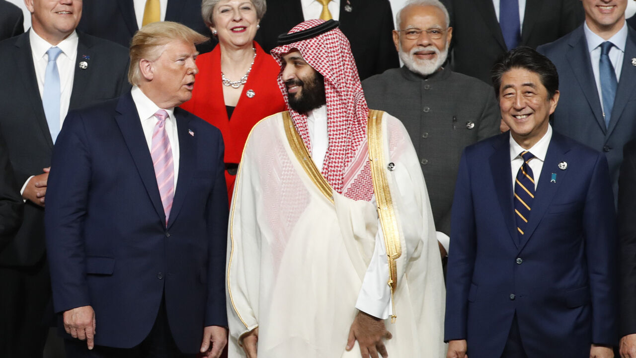 1152459976 OSAKA, JAPAN - JUNE 28: U.S. President Donald Trump speaks with Saudi Arabia's Crown Prince Mohammed bin Salman during a family photo session at G20 summit on June 28, 2019 in Osaka, Japan. U.S. President Donald Trump arrived in Osaka on Thursday for the annual Group of 20 gathering together with other world leaders who will use the two-day summit to discuss pressing economic, climate change, as well as geopolitical issues. The US-China trade war is expected to dominate the meetings in Osaka as President Tr