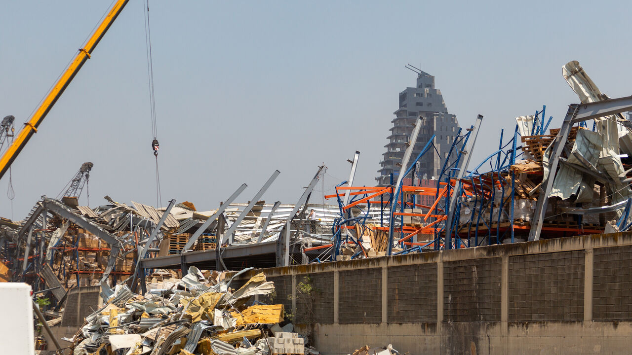 1228408488 BEIRUT, LEBANON - SEPTEMBER 08: Workers continue to remove debris, damaged cars, and destroyed warehouses from last month's explosion at the Port’s Free Zone on September 8, 2020 in Beirut, Lebanon. Lebanon's army says they have found more than four tonnes of ammonium nitrate near the port entrance, the same substance that caused the August 4 blast. Last month's explosion at Beirut's port killed over 200 people, injured thousands, and upended countless lives. (Photo by Haytham Al Achkar/Getty Images)