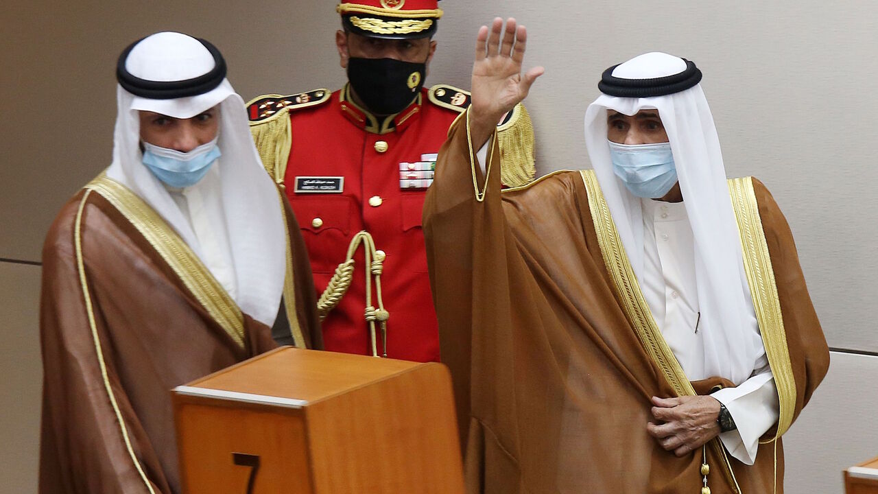1228798931 Sheikh Nawaf al-Ahmad Al-Sabah (R) salutes the crowd after being sworn in as Kuwait's new Emir at the National Assembly in Kuwait City, as Parilament Speaker Marzouq al-Ghanem looks on, on September 30, 2020. - Kuwait today swore in its new emir, Sheikh Nawaf al-Ahmad Al-Sabah, after the death of his half-brother, Sheikh Sabah, who died in the US at the age of 91. (Photo by Yasser Al-Zayyat / AFP) (Photo by YASSER AL-ZAYYAT/AFP via Getty Images)