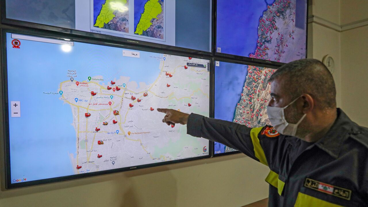 1228898786 Volunteers at the Lebanese Civil Defence work in the the control room at the headquarters of the public emergency service in the capital Beirut, on September 28, 2020. - Sweeping forest fires, a monster explosion that killed friends, then bizarre Beirut blazes: Lebanon's rescuers are still reeling from a devastating year, but are determined to press on. (Photo by ANWAR AMRO / AFP) (Photo by ANWAR AMRO/AFP via Getty Images)