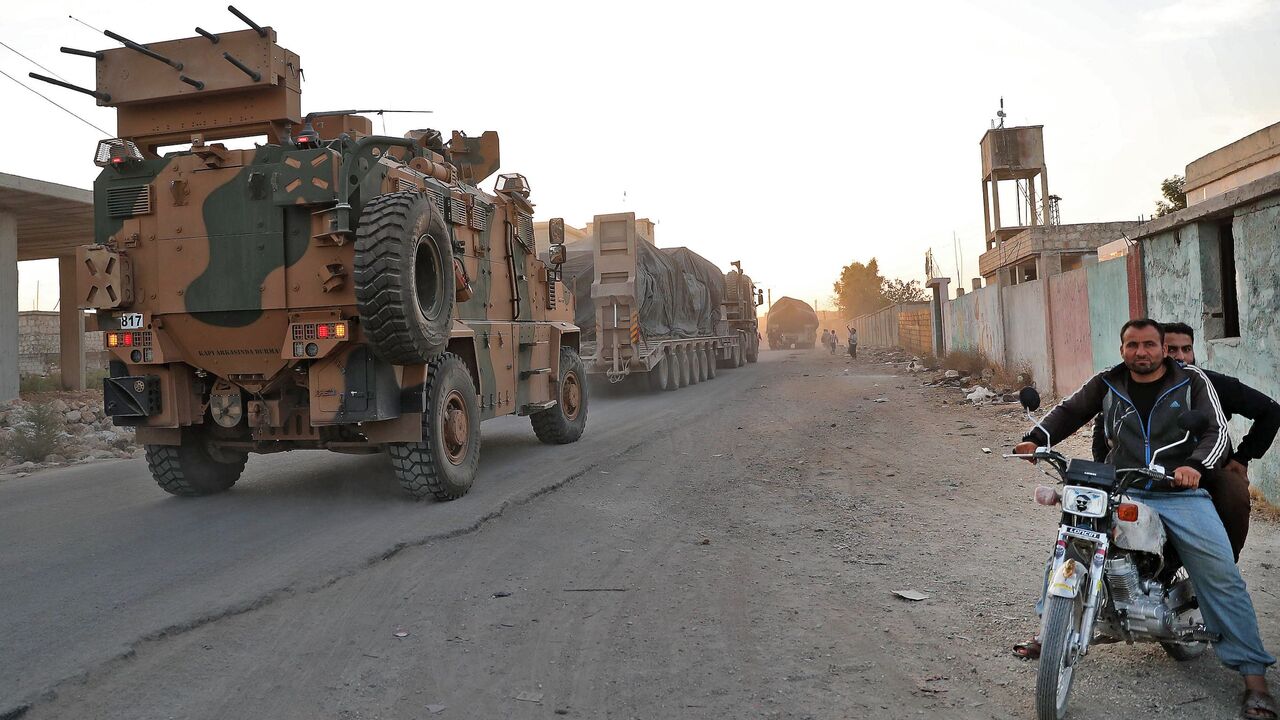 1229184018 A Turkish military convoy drives through the village of Iblin, near Ariha in Syria's rebel-held northwestern Idlib province on October 20, 2020 after vacating the Morek post in Hama's countryside. - Turkey started withdrawing from one of its largest outposts in northwest Syria encircled for the past year by Syrian regime forces, a war monitor and a pro-Ankara rebel commander said. The outpost in Morek is Turkey's largest in the northwest province of Hama, which is now mostly under Syrian government control.