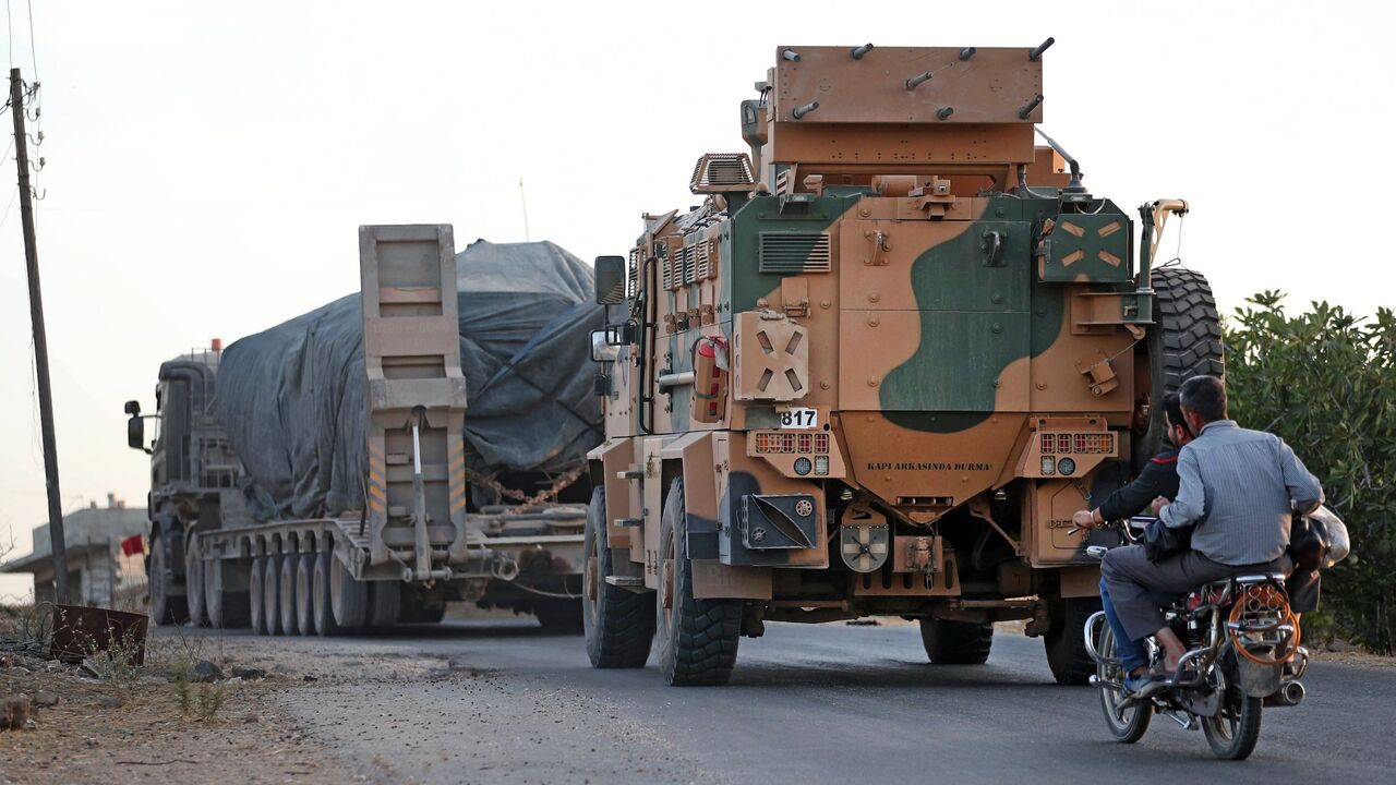 1229184088 A Turkish military convoy drives through the village of Iblin, near Ariha in Syria's rebel-held northwestern Idlib province on October 20, 2020 after vacating the Morek post in Hama's countryside. - Turkey started withdrawing from one of its largest outposts in northwest Syria encircled for the past year by Syrian regime forces, a war monitor and a pro-Ankara rebel commander said. The outpost in Morek is Turkey's largest in the northwest province of Hama, which is now mostly under Syrian government control.