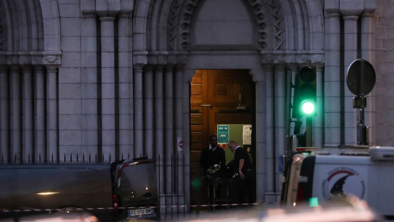 1229344259 French coroners carry the second body of one of the three people killed at the Notre-Dame de l'Assomption Basilica in Nice, southern France, on October 29, 2020 after a knife-wielding man slitted the throat of at least one of the victims, in what officials are treating as the latest jihadist attack to rock the country. - The assailant, who was shot and wounded by police, was identified as Brahim Aouissaoui, a 21-year-old Tunisian migrant who arrived in Italy in late September and later travelled to France,