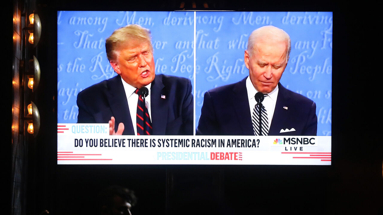1277476625 WEST HOLLYWOOD, CALIFORNIA - SEPTEMBER 29: A broadcast of the first debate between President Donald Trump and Democratic presidential nominee Joe Biden is played on a TV at The Abbey, which seated patrons at socially distanced outdoor tables, on September 29, 2020 in West Hollywood, California. The debate being held in Cleveland, Ohio is the first of three scheduled debates between Trump and Biden. (Photo by Mario Tama/Getty Images)