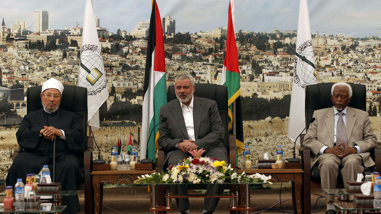 PALESTINIAN-ISRAEL-GAZA-ISLAM-SUDAN Hamas Prime Minister Ismail Haniyeh (C) meets with Egyptian Cleric and chairman of the International Union of Muslim Scholars Sheikh Yusuf al-Qaradawi (L) and former Sudanese president Abdel Rahman Swar Al Dahab (R) after their arrival in Gaza City on May 9, 2013. Al-Qaradawi arrived on May 8, 2013 for his first visit to Gaza Strip with a delegation of Muslim scholars. AFP PHOTO /MOHAMMED ABED (Photo credit should read MOHAMMED ABED/AFP via Getty Images)